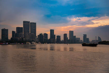 Shanghai city skyline seen from water at sunset, China