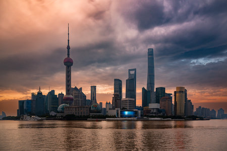 Shanghai city skyline seen from water at sunset, Chinaの写真素材