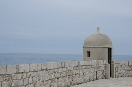 View of the gun turret on Dubrovnik city walls and sea in Croatiaの写真素材