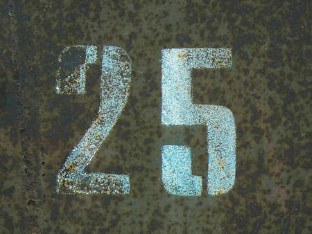 stenciled numbers 25 on a brown rusty backgroundの写真素材