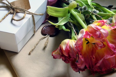 Bouquet of delicate pink tulips and boxes with giftsの写真素材