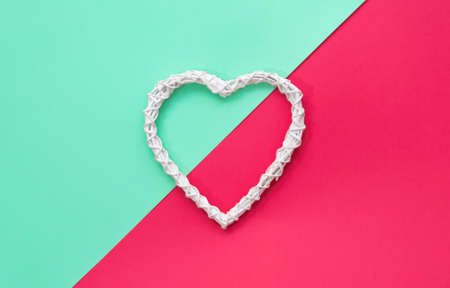 Rustic wooden white heart on colorfull backgrond. Green and red layout.の写真素材