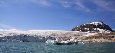 Glacier walking on Jostedalsbreen in Norway. People and scale visable in big format. The lake is...