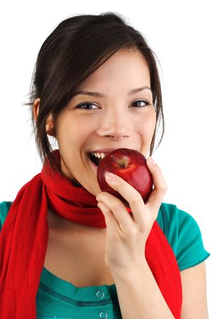 Beautiful autumn woman eating a red apple. Isolated on white background.の写真素材