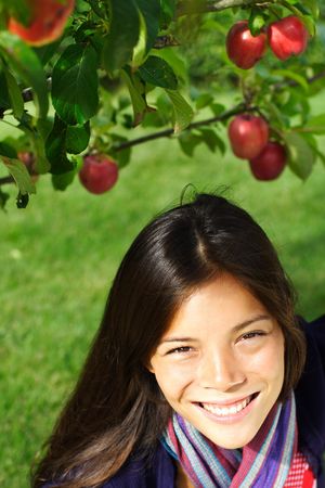 Autumn woman under apple treeの写真素材
