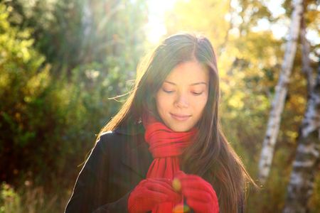  Woman lost in her thoughts walking in authumn forest. Very beautiful pro model.の写真素材
