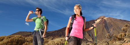 Hiking. Young couple hiking / backpacking in very scenic and beautiful volcanic landscape on the volcano, Teide, Tenerife, Spain. の写真素材