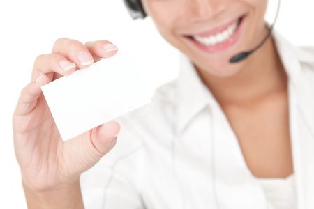Businesswoman with headset holding business card. Beautiful young mixed race asian / caucasian woman isolated on white background.の写真素材