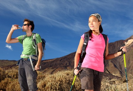 Hikers. Young couple  hiking / backpacking in very scenic and beautiful volcanic landscape on the volcano, Teide, Tenerife, Spain. の写真素材