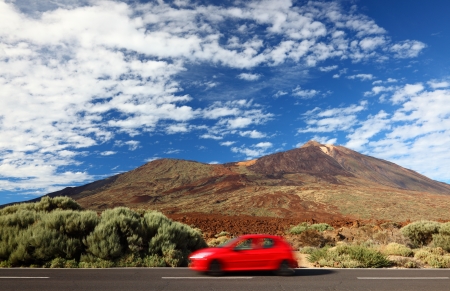 Road trip car in beautiful landscape with copy space. Mountains and volcano Teide, Tenerife in the backgroundの写真素材