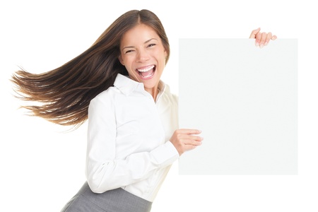 Energetic portrait of young businesswoman holding a blank empty poster with copy space. Beautiful young smiling woman isolated on white background.の写真素材