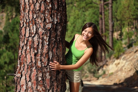 Fresh beautiful smiling woman in summer forest playful. Image from pine tree forest near Vilaflor, Tenerife, Canary Islands.の写真素材