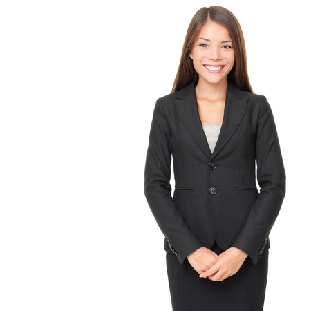 Businesswoman isolated on white background. Young smiling Asian / Caucasian business woman in suit standing looking at cameraの写真素材