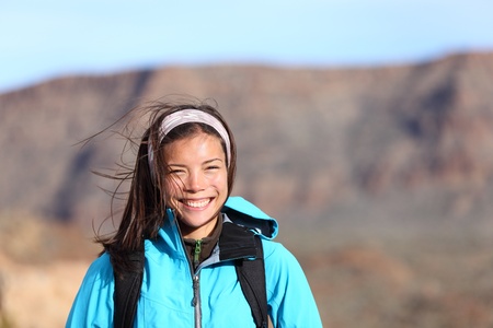 Hiker woman smiling happy during outdoors hiking. Very fresh sporty Asian Caucasian female model.の写真素材