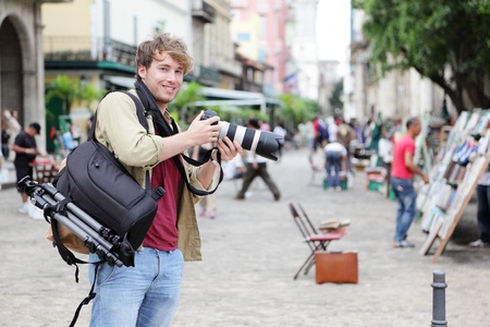 Travel photographer, Havana, Cuba on Plaza de Armas in Old Havana with Camera equipment taking pictures.の写真素材