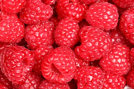 Raspberries - raspberry texture background of fresh red ripe berries. Close up image with great...
