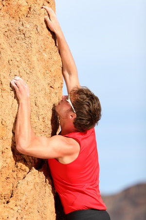Climbing  Rock climber free climbing  Strong fit man fitness sport model hanging on vertical cliff の写真素材