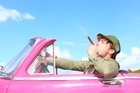 Cuba concept  Vintage car with cigar smoking man with Fidel Castro patrol cap  Funny image cuban...