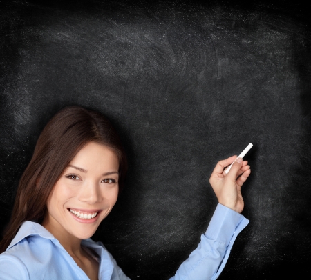 Teacher teaching or young student writing on blackboard   chalkboard with chalk an copy space for your textの写真素材