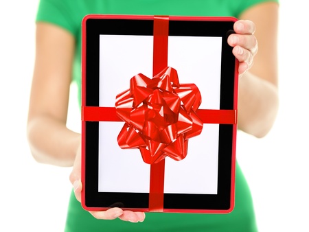 Closeup of woman showing and giving digital tablet computer as present or christmas giftの写真素材
