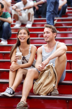 Happy multi ethnic young couple on date enjoying coffeeの写真素材