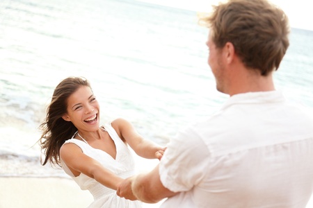 Happy young couple having beach fun on vacation travel holidaysの写真素材