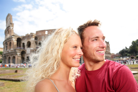 Tourist couple in Rome by Coliseum on travel dating laughing having funの写真素材