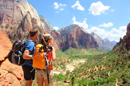 Hiking - hikers looking at view in Zion National park.の写真素材