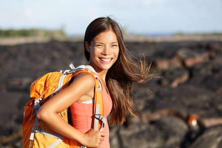 Hiking woman - hiker walking on lava field on Hawaii. Tourist on hike near Kilauea volcano around Hawaii volcanoes national park, USA.の写真素材