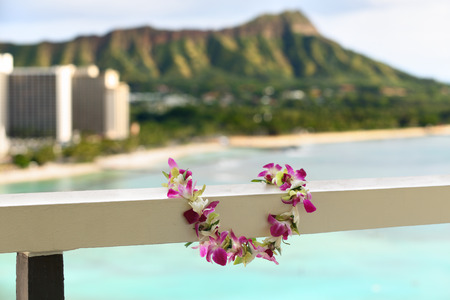 Hawaii travel icon: Lei flower necklace in front of Waikiki beach and Diamond Head state monument in Honoluluの写真素材