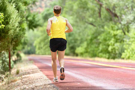 Running man runner jogging for fitness and health. Male athlete on working out on run wearing sports...