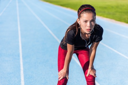 Runner resting on outdoor running track tired taking a break getting determination and motivation...