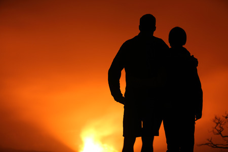 Hawaii scene. Hiking people looking at Hawaiian volcano lava glow at night: Halemaumau crater within the Kilauea Volcano caldera in Hawaii volcanoes national park on Big Island.の写真素材