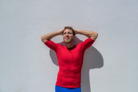 Fitness athlete man tired with headache or depresssion sweating breathing after difficult training. Mental health in sports, psychological help.の写真素材