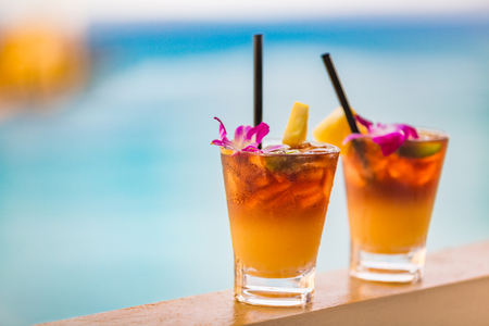 Hawaii mai tai drinks on waikiki beach swimming pool bar travel vacation in Honolulu, Hawaii. Alcohol cocktails with ocean view, luau party nightlife at club.の写真素材