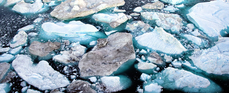 Climate Change and Global Warming - Icebergs and from melting glacier in icefjord in Ilulissat,...