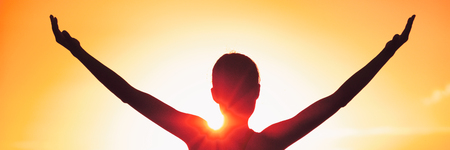 Freedom woman with open arms silhouette against sunset banner. Yoga girl doing sun salutation. Carefree person living a free life. Panorama horizontal banner crop for success freedom concept.の写真素材