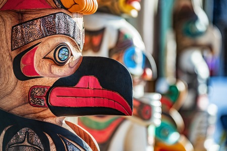 Alaska totem pole carving art sculture store in tourist travel attraction town on Alaska cruise. Ketchikan, Juneau, Skagway stores and shops selling native paintings and art. Closeup of an Eagle.の写真素材