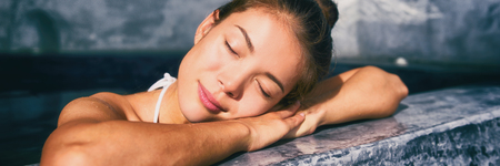 Luxury pampering woman at wellness pool spa relaxing in luxury resort. Hot tub bathtub at hotel holiday weekend getaway. Banner panorama.の写真素材