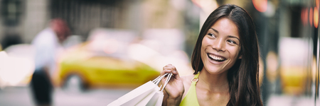 Shopping in New York City Asian woman smiling happy holding shopping bag panoramic banner...
