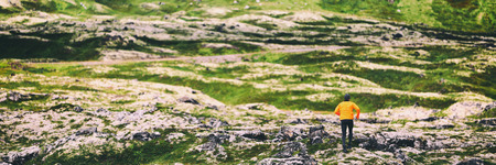 Trail run athlete running on winter mountain nature background panoramic banner. Endurance sport hiker on trek hike. Landscape crop header.の写真素材