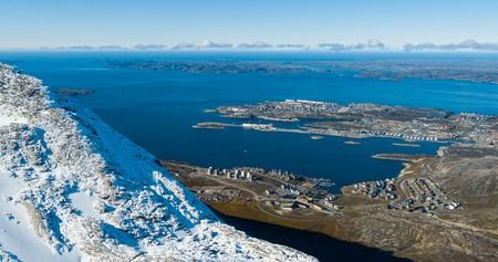 Greenlands capital Nuuk - largest city in Greenland aerial view. Drone image of Nuuk from air, aka Godthaab seen from Mountain Sermitsiaq also showing Nuup Kangerlua fjord.の写真素材