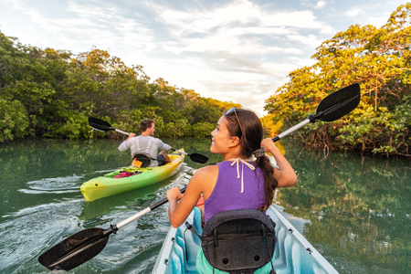 Couple kayaking together in mangrove river of the Keys, Florida, USA. Tourists kayakers touring the river of Islamorada.の写真素材