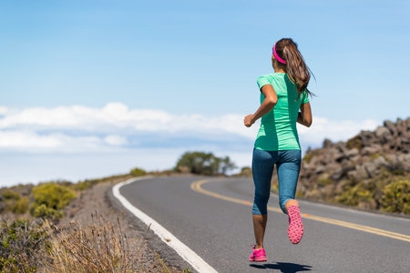 Running runner woman on run goal challenge. Fitness girl training cardio on road to success.の写真素材