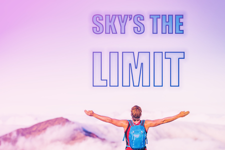 SKY'S THE LIMIT sentence written on pink sky with clouds at sunset copy space. Man with open arms inspirational picture for motivational quote for life challenge for success. Reach your goals.の写真素材