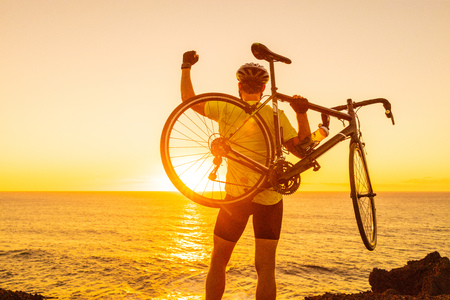 Success, achievement and winning concept with cyclist man road biking. Happy male professional...