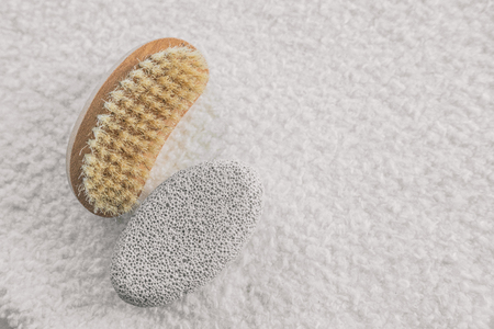 Bath spa brush for pedicure exfoliation. Nail brush and exfoliation pumice volcanic stone for dry cracked feet calluses massage.の写真素材