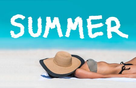 SUMMER title written on beach vacation background. Holidays travel bikini suntan woman asleep sun tanning covering face with hat. SUMMER text for holiday concept in blue ocean copyspace above.の写真素材