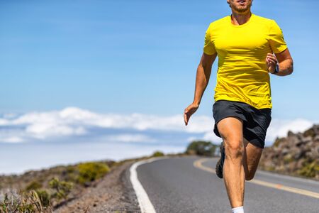 Running man on outdoor road run runner in sports clothing sprinting in speed - active lifestyle athlete living a healthy life.の写真素材