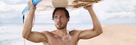 Sexy surfer man going surfing on beach banner panorama. Watersport fitness lifestyle athlete...